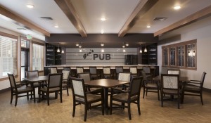 Geo's Pub sign and bar area with stools, table and chairs