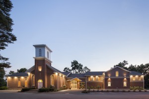 Exterior church building at night with lights on