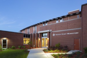 exterior image of front entry monastery at night